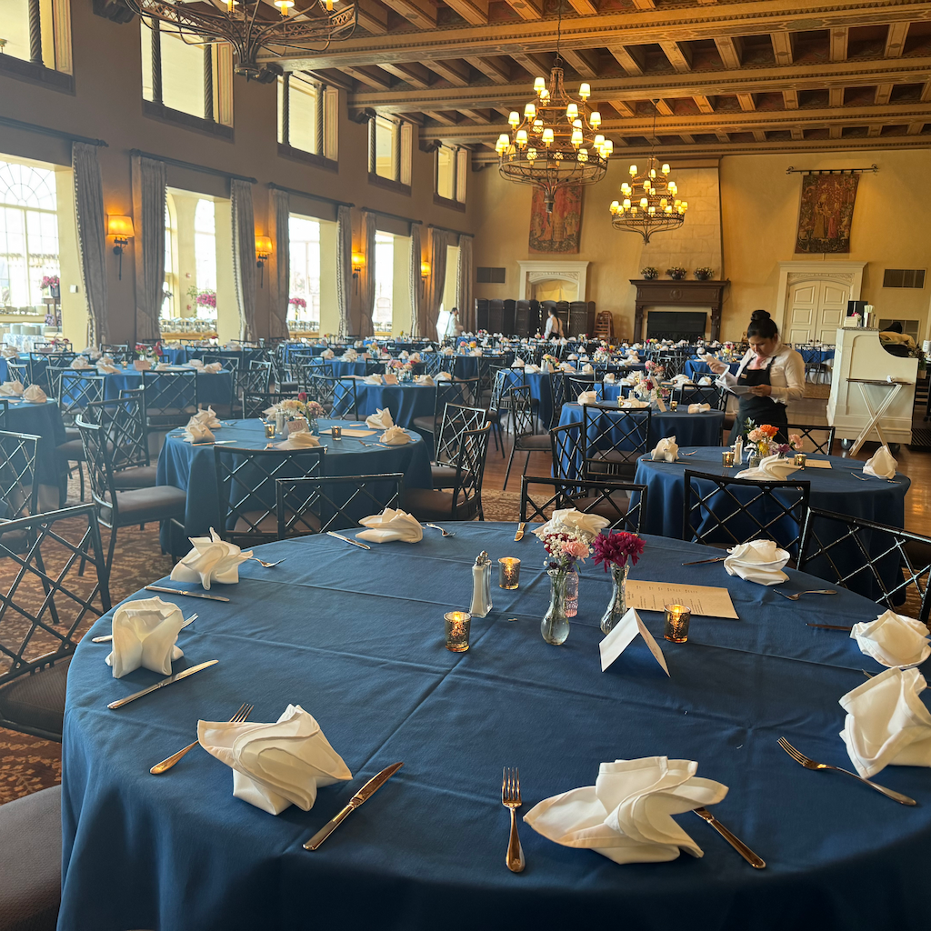 Professional hospitality staff setting an elegant fine dining table